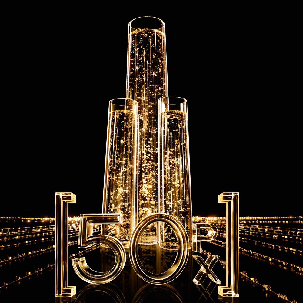 Drei vertikale Glasrohren gefullt mit funkelnder goldener Flussigkeit, mit leuchtenden "50X"-Zahlen davor, auf schwarzem Hintergrund mit goldenen Lichtspuren.
