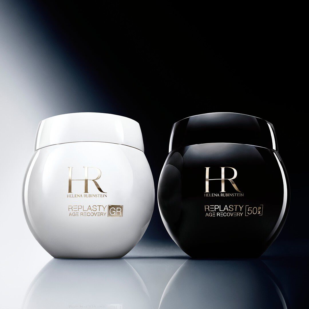 A side-by-side studio presentation of two luxury Helena Rubinstein creams on a glossy reflective surface. 
